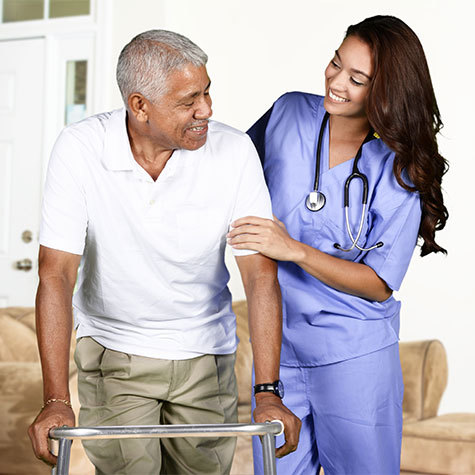 care-provider-helping-man-with-walker