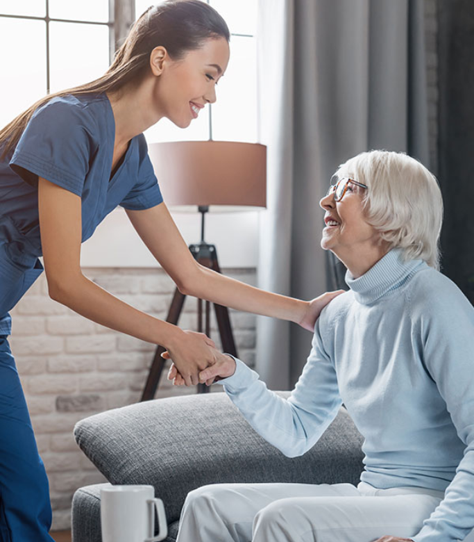 care-provider-helping-senior-off-of-couch